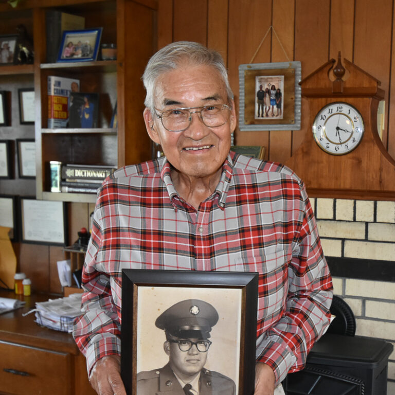 Dante Belvin holds his military portrait