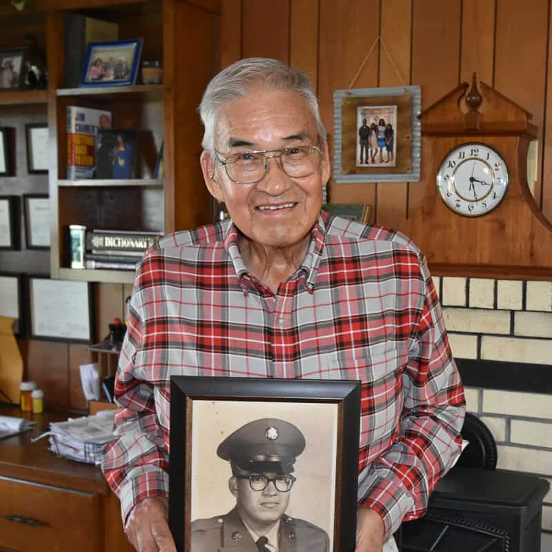 Dante Belvin holds his military portrait